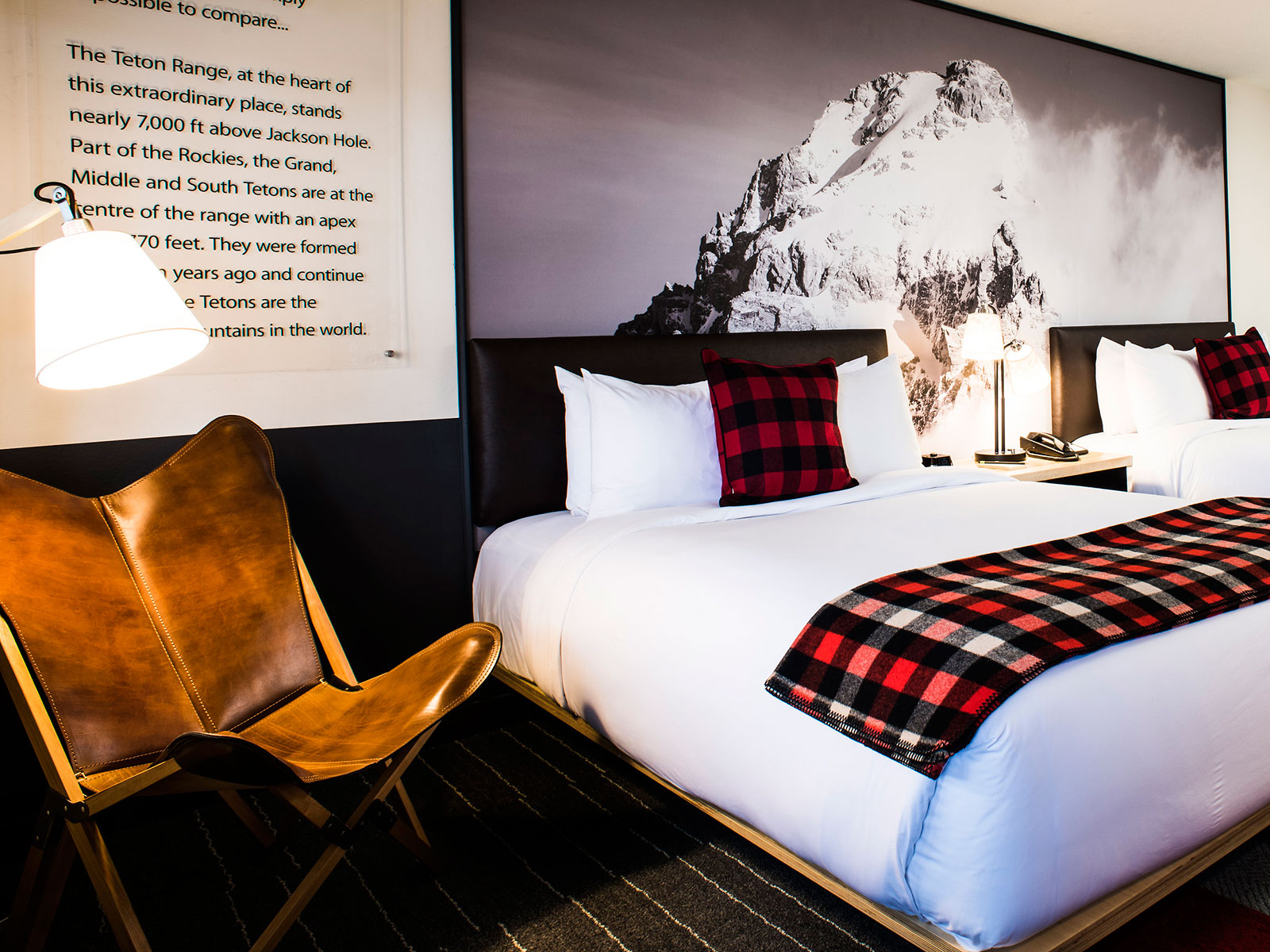 Mountain Modern Motel Guestroom with beds, sitting area and decor of a mountain peak