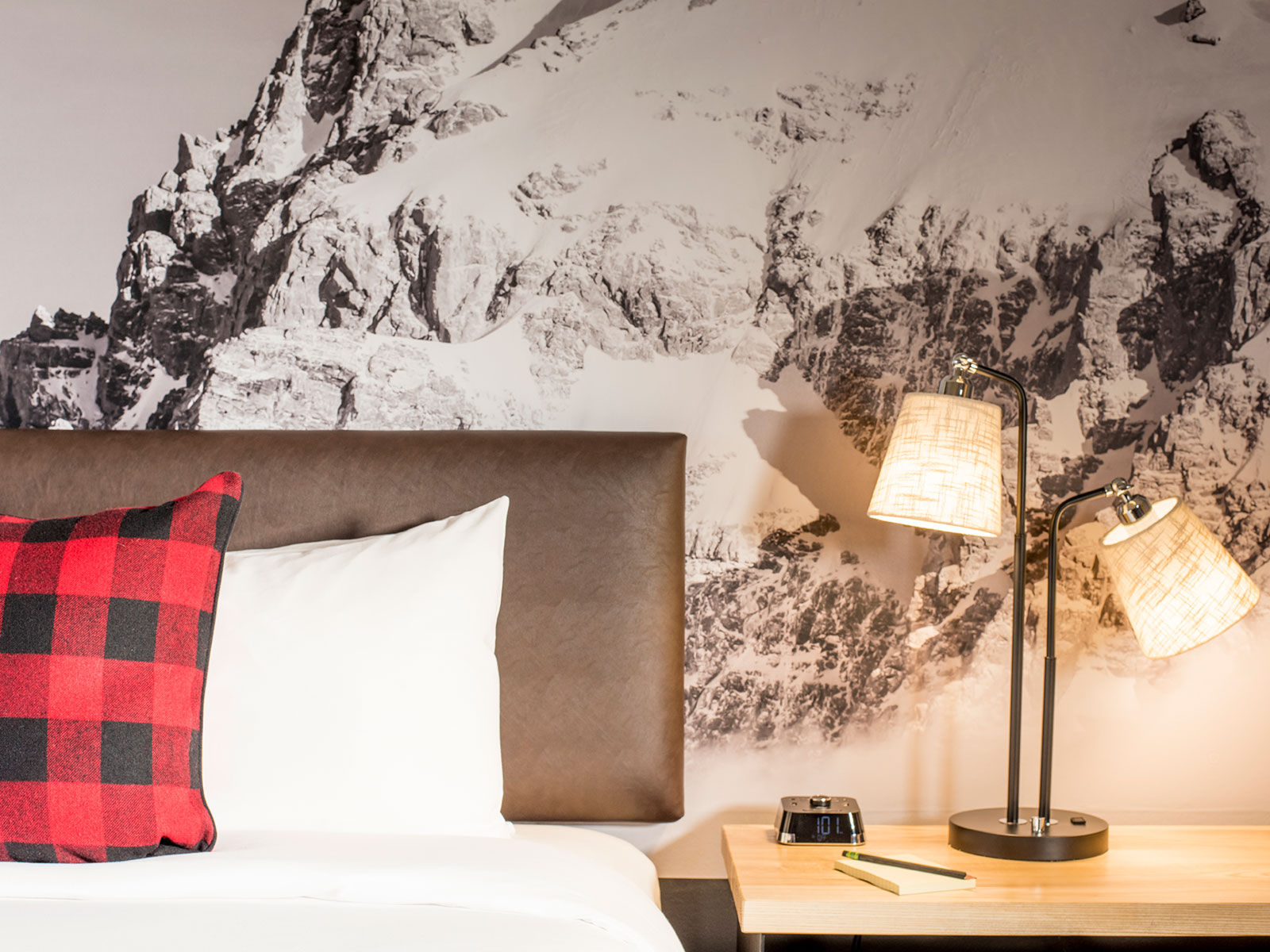 Mountain Modern Motel bed with bedside lamp