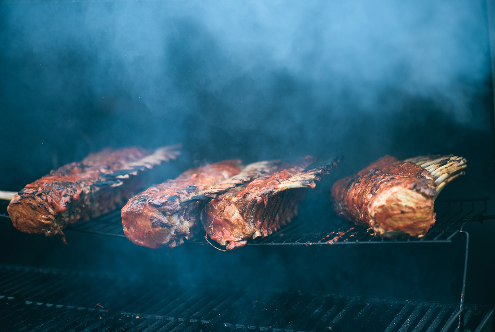 Four racks of lamb on a grill