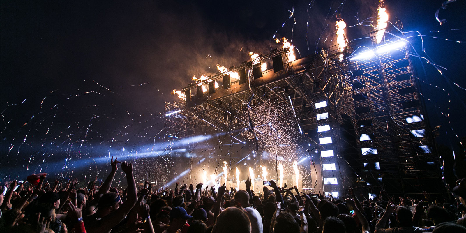 Outdoor music stage with pyrotechnics and crowd