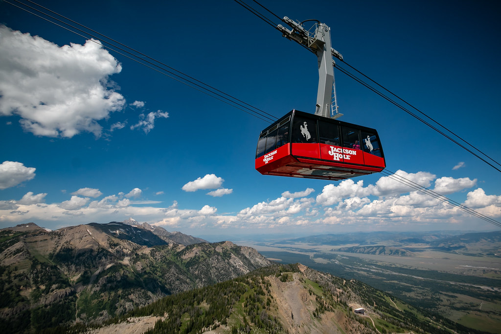 Jackson Hole Resort Arial tram in summer on partly cloudy day overlooking Jackson Hole valley