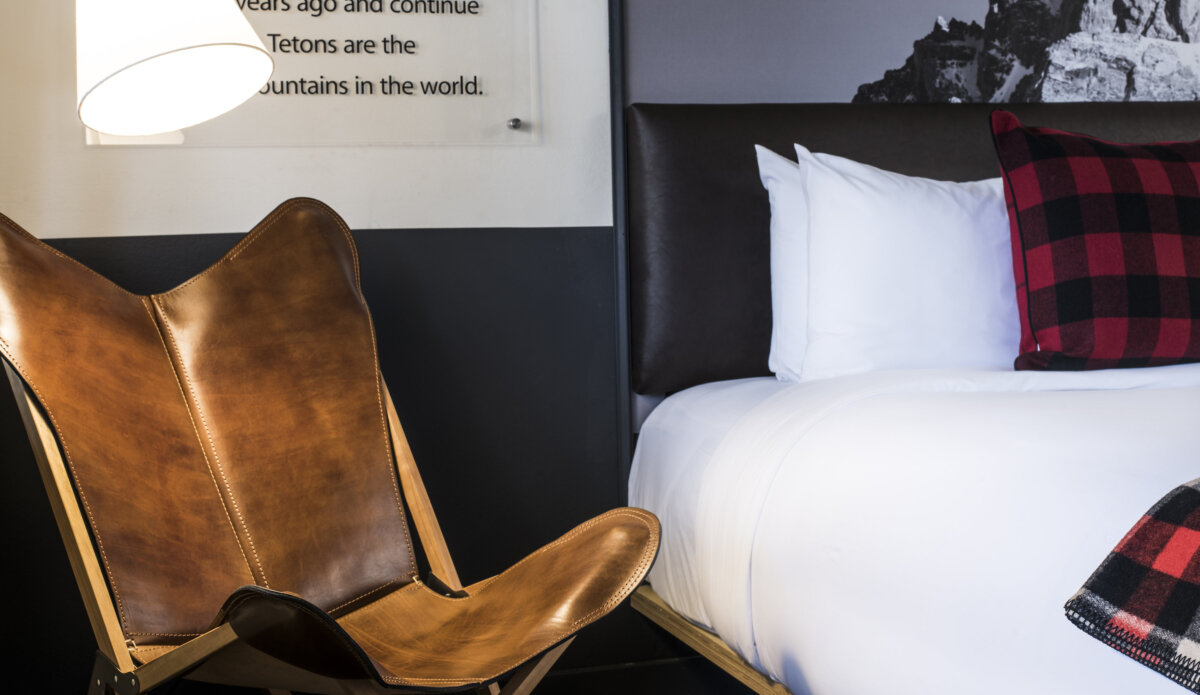 Leather chair next to bed in guestroom