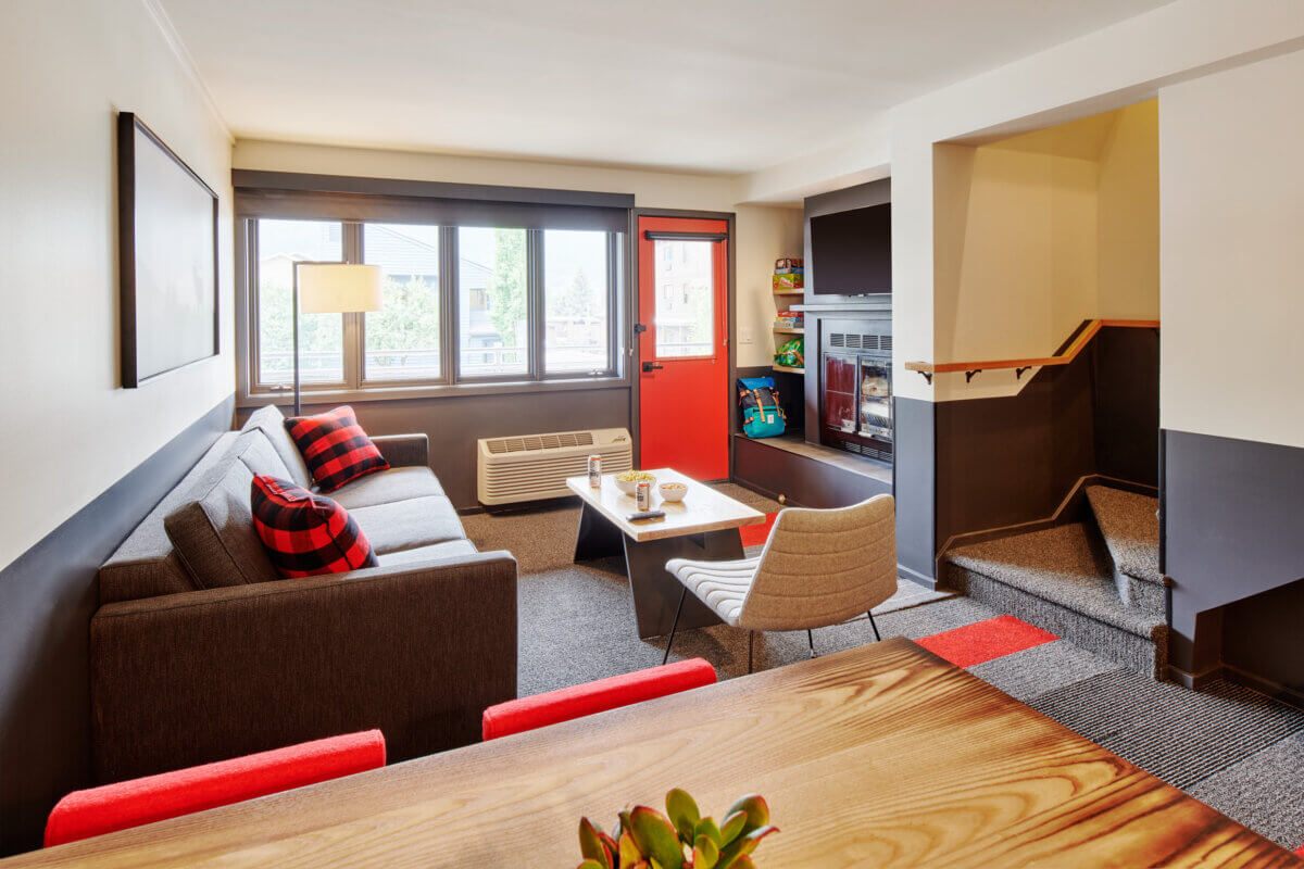 Two Bedroom Suite table, living room, fireplace, stairs towards balcony