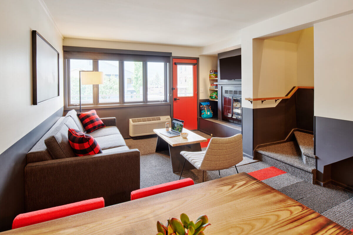 Two Bedroom Suite table, living room, fireplace, stairs towards balcony